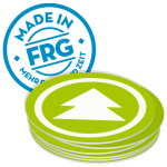 Runder Sticker mit der Aufschrift 'Made in FRG' und einem grünen Pfeil auf einem Stapel von Aufklebern.