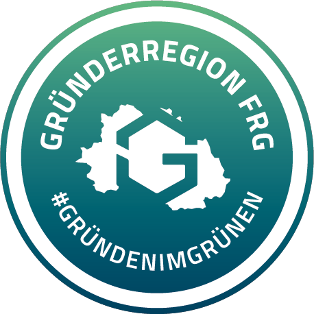 Rundes Logo der Gründerregion FRG mit stilisiertem Kartenmotiv und Schriftzug.